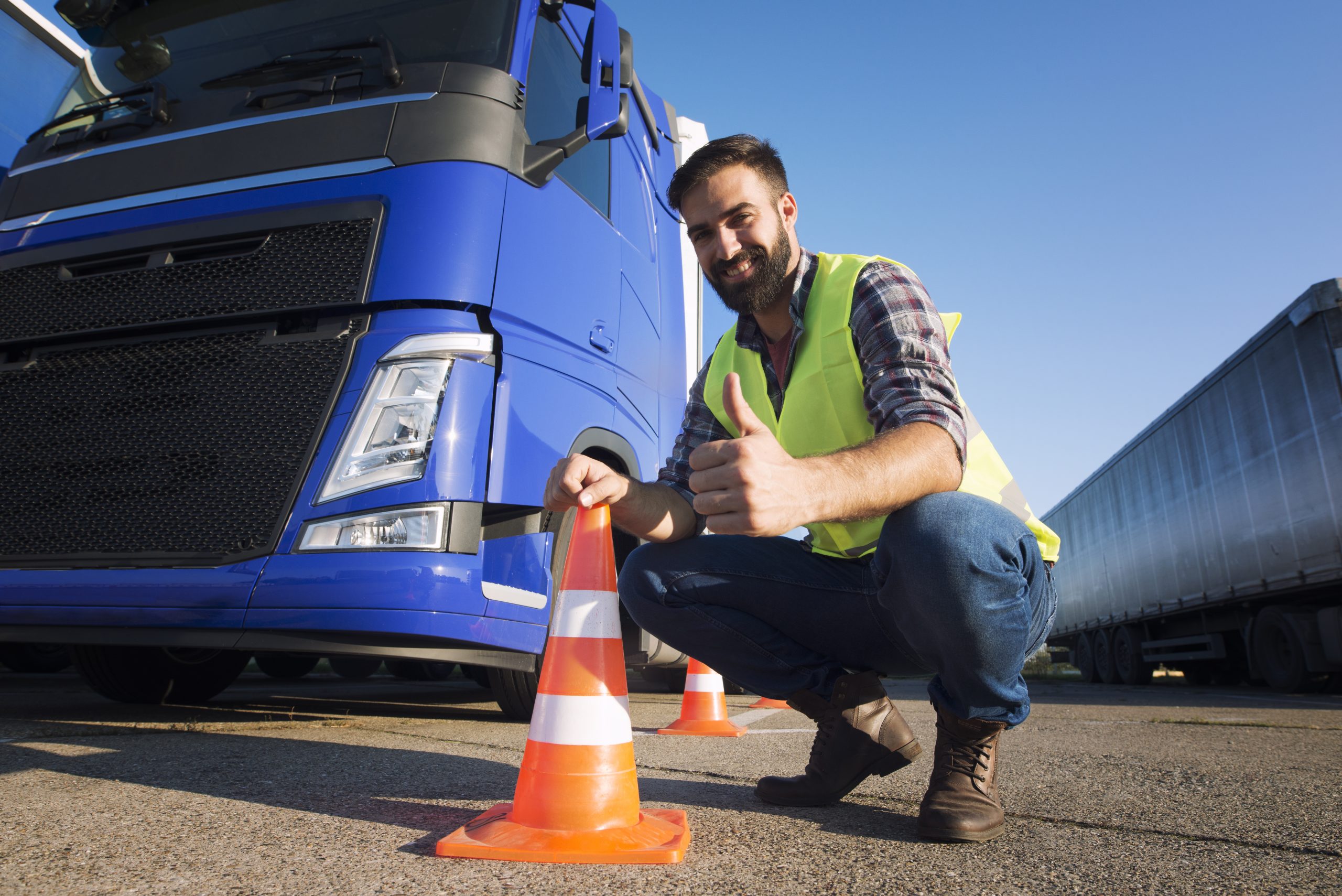man learning how drive truck driving schools scaled